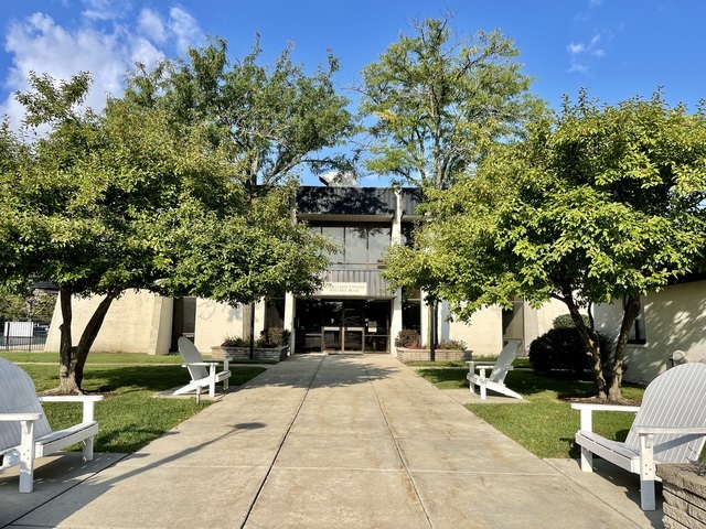 9701 North Dee Road, Unit 5M Niles, IL 60714 - Photo 15 of 21 a front view of a house with a tree