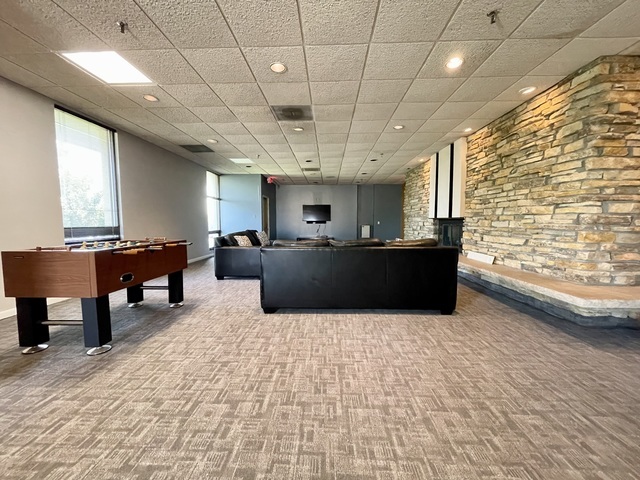 9701 North Dee Road, Unit 5M Niles, IL 60714 - Photo 17 of 21 a living room with furniture a window and a table