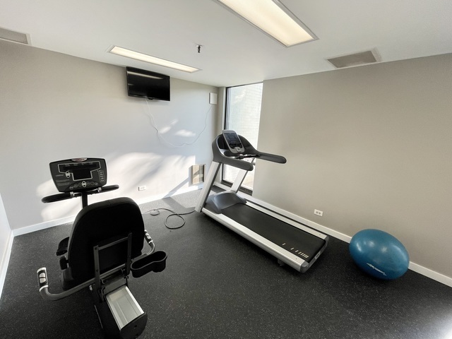 9701 North Dee Road, Unit 5M Niles, IL 60714 - Photo 20 of 21 a living room with furniture and a window