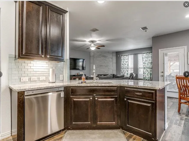 a kitchen with cabinets and stainless steel appliances
