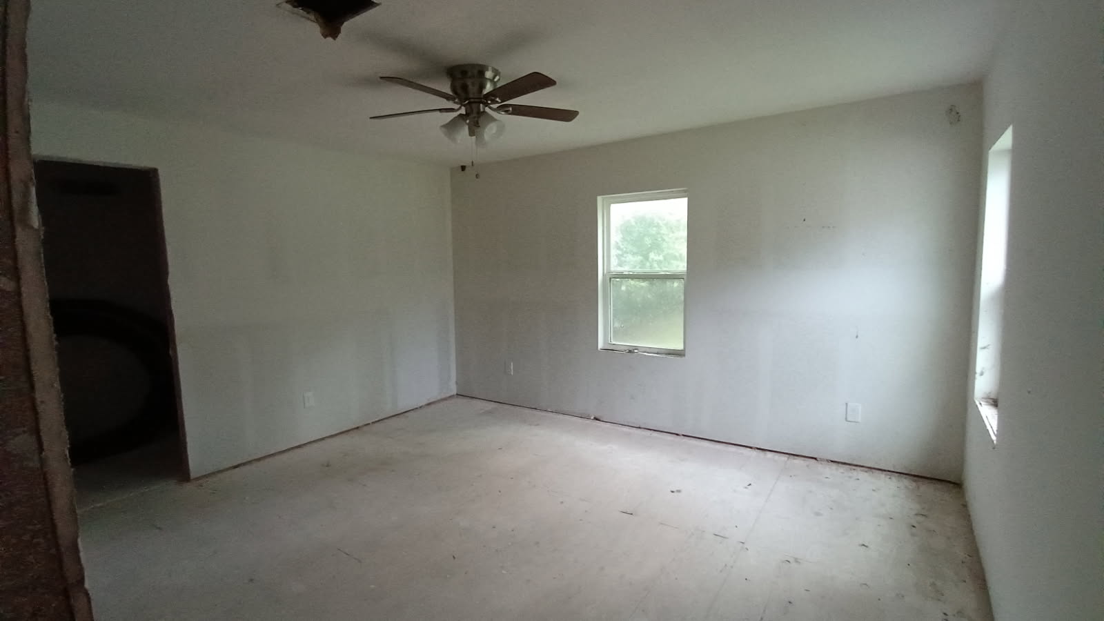 112 Ila Street Elgin, TX 78621 - Photo 9 of 27 an empty room with a window and a fan