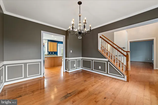 a view of an empty room with wooden floor a fireplace