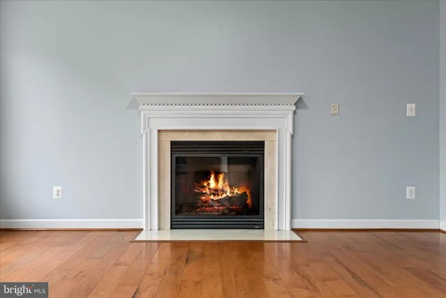 a view of a hallway with wooden floor and a cabinet