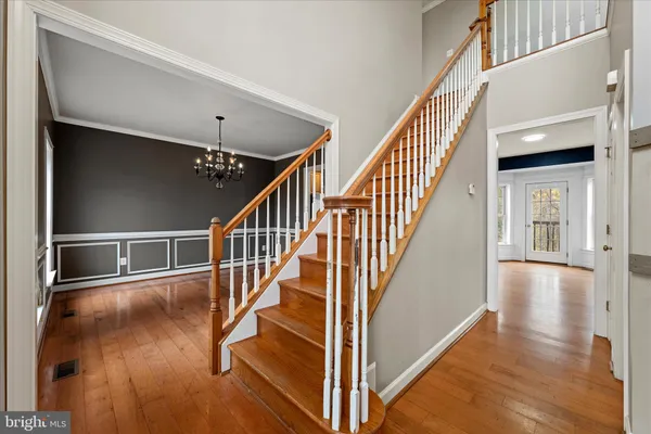a view of empty room with wooden floor and ceiling fan