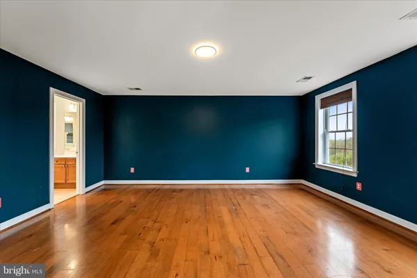 a view of a livingroom with a ceiling fan and wooden floor