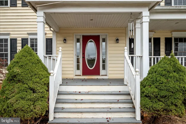 a view of a hallway with wooden floor and entryway