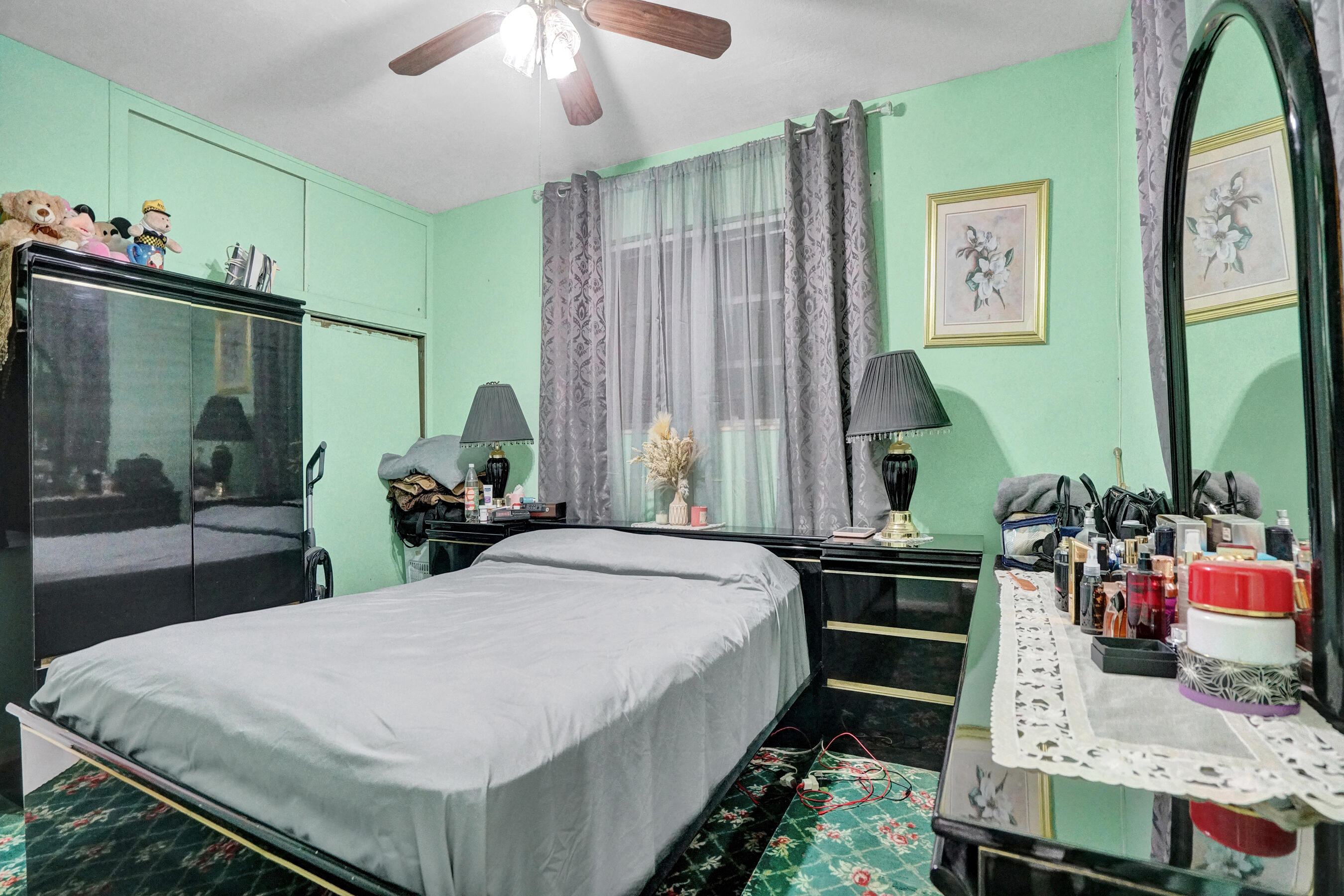 640 Northeast 24th Street Pompano Beach, FL 33064 - Photo 19 of 35 a bed room with a bed window and a flat tv screen