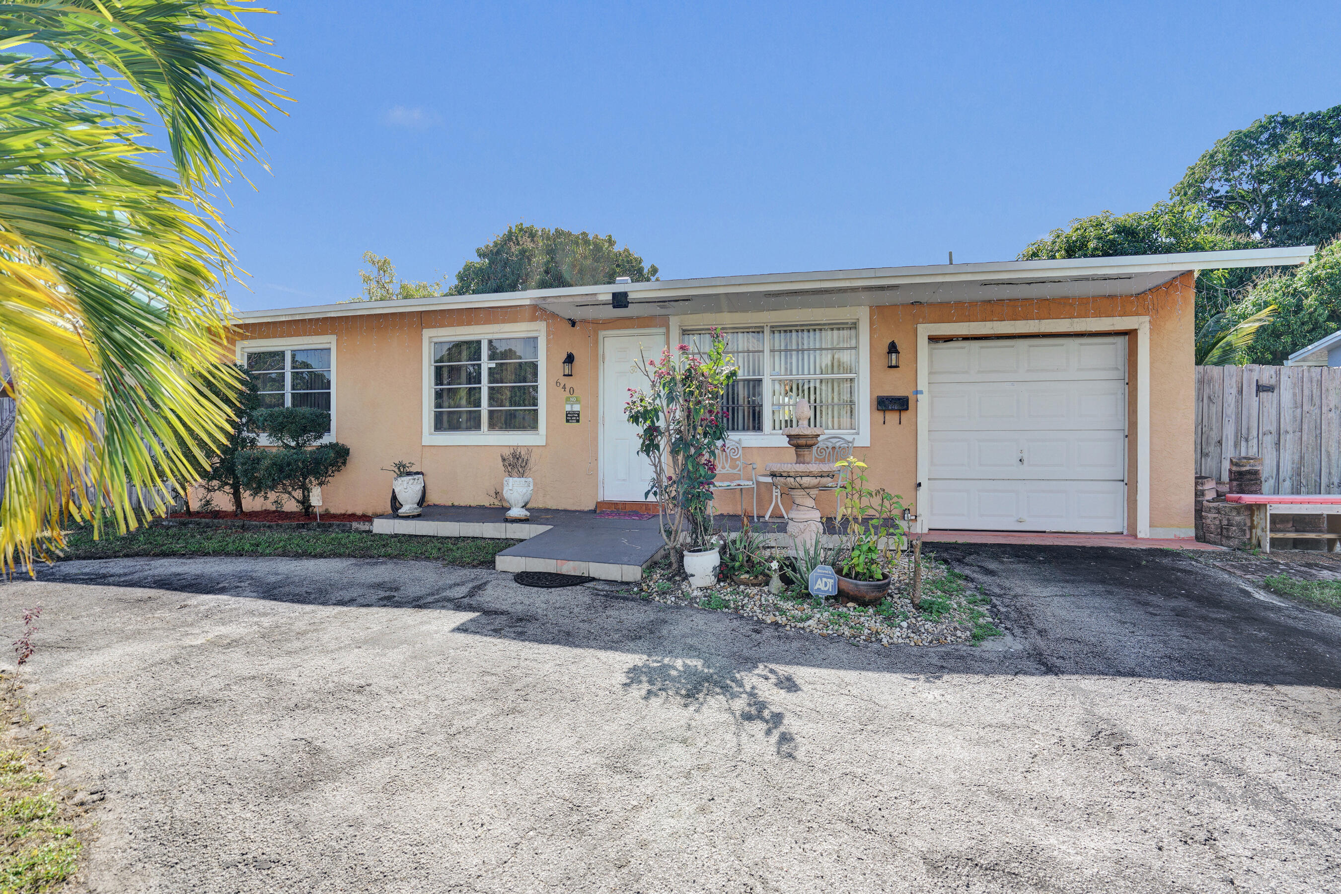 640 Northeast 24th Street Pompano Beach, FL 33064 - Photo 24 of 35 a front view of a house with garden