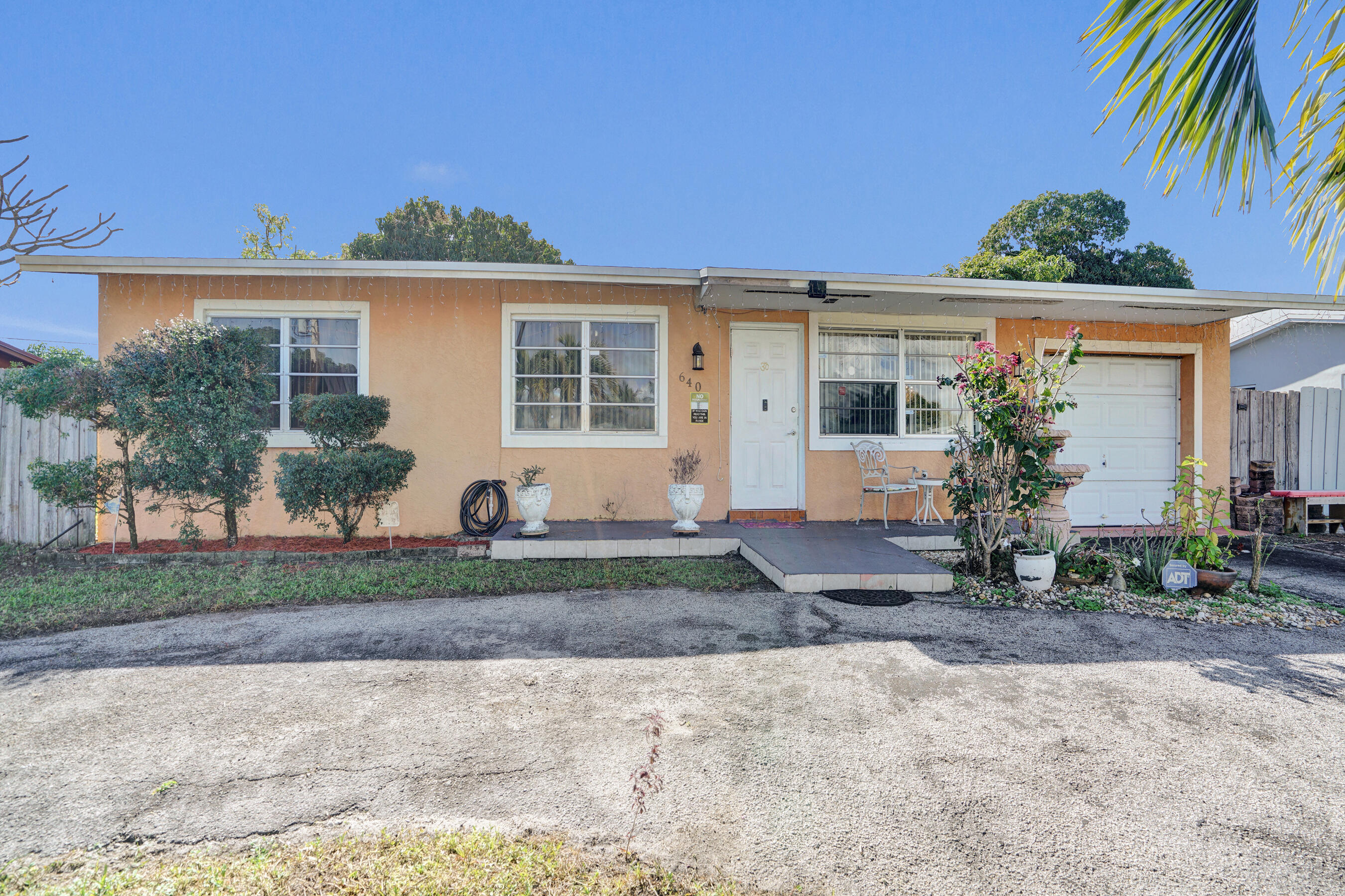 640 Northeast 24th Street Pompano Beach, FL 33064 - Photo 26 of 35 a front view of a house with garden