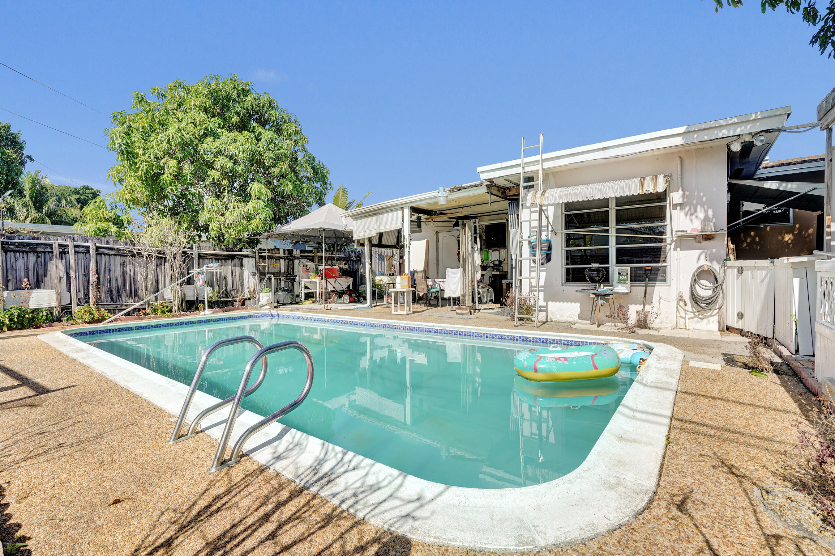 640 Northeast 24th Street Pompano Beach, FL 33064 - Photo 28 of 35 a view of a house with swimming pool and porch
