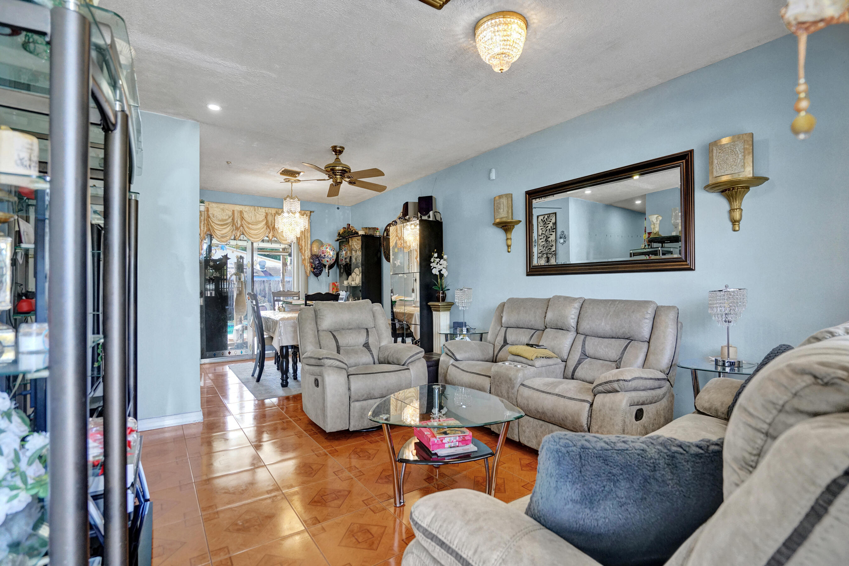 640 Northeast 24th Street Pompano Beach, FL 33064 - Photo 5 of 35 a living room with furniture and a chandelier