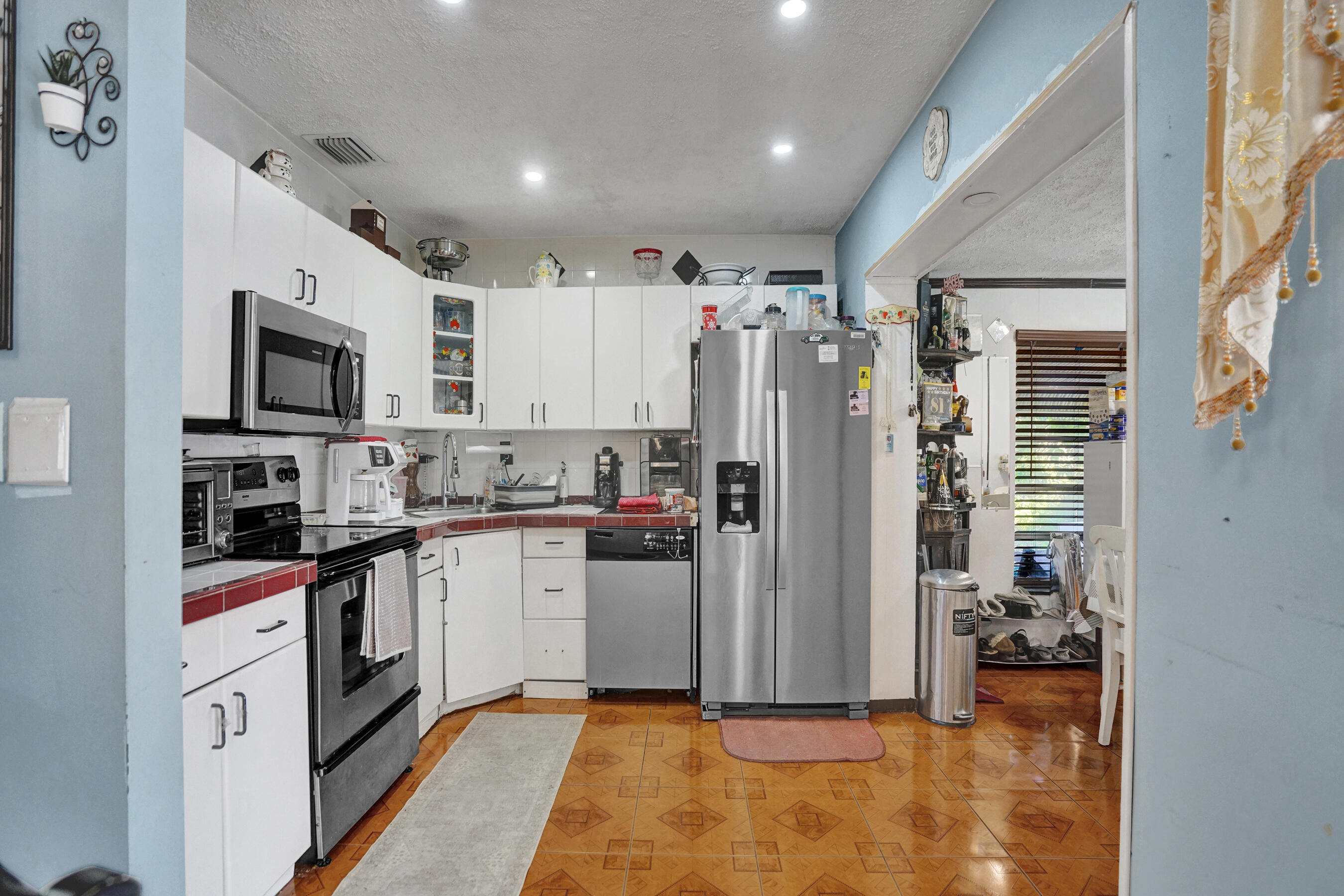 640 Northeast 24th Street Pompano Beach, FL 33064 - Photo 7 of 35 a kitchen with stainless steel appliances granite countertop a refrigerator and a stove top oven