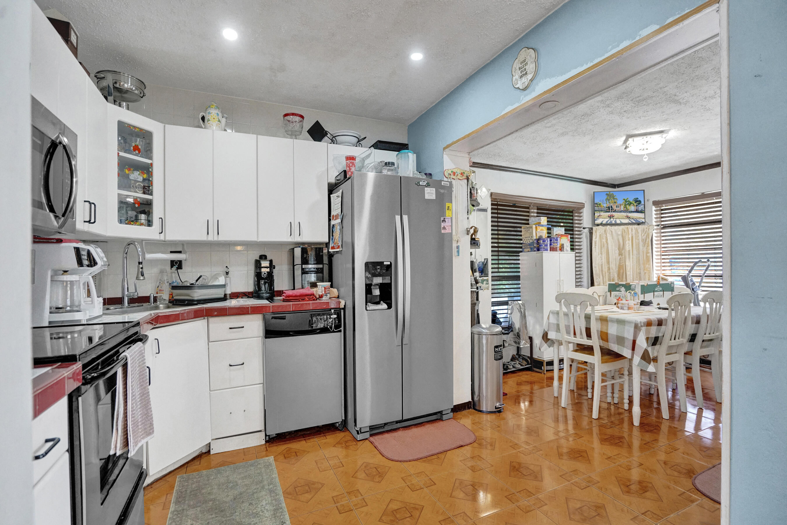 640 Northeast 24th Street Pompano Beach, FL 33064 - Photo 8 of 35 a kitchen with stainless steel appliances granite countertop a refrigerator and a stove top oven