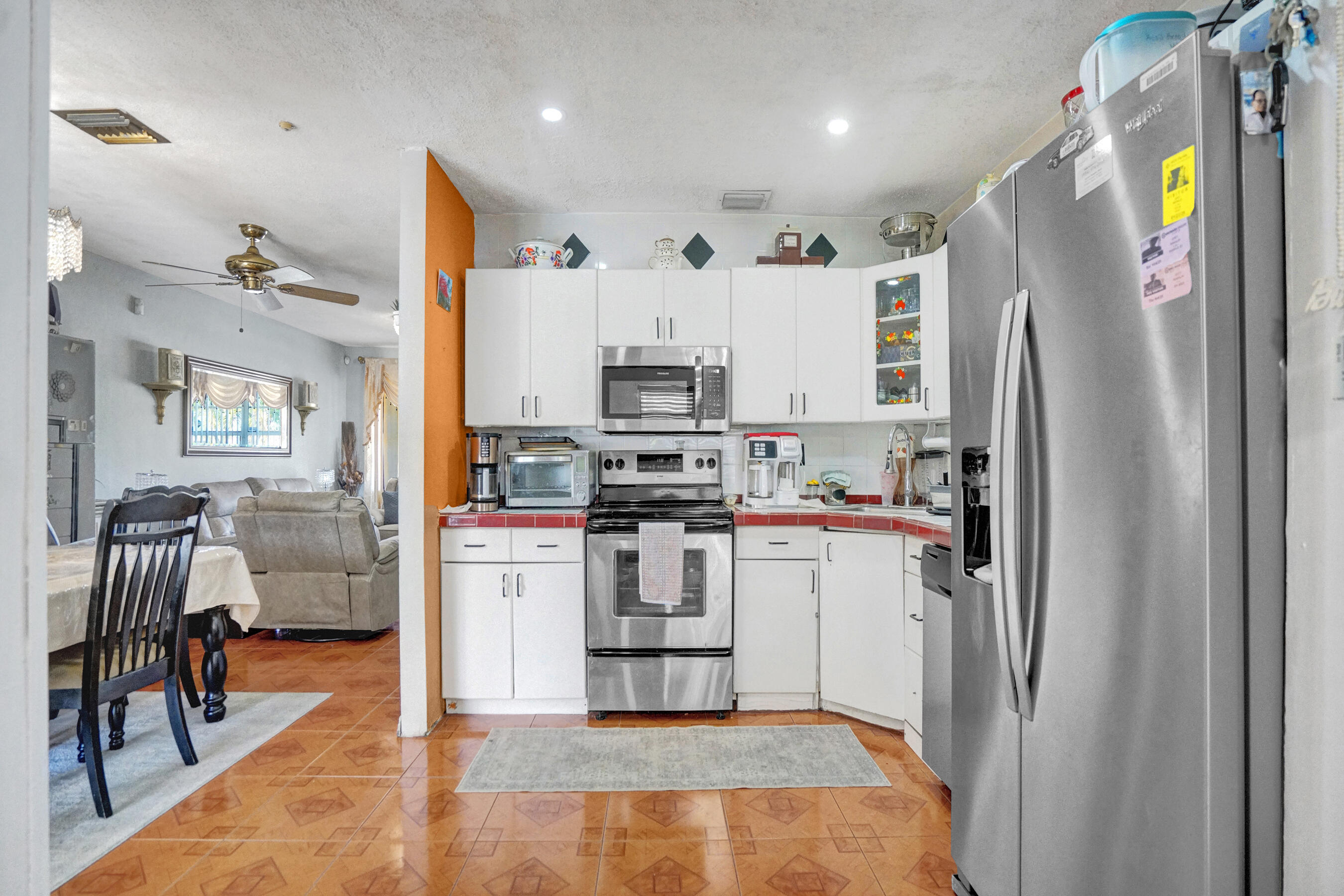 640 Northeast 24th Street Pompano Beach, FL 33064 - Photo 9 of 35 a kitchen with stainless steel appliances granite countertop a refrigerator and a stove top oven
