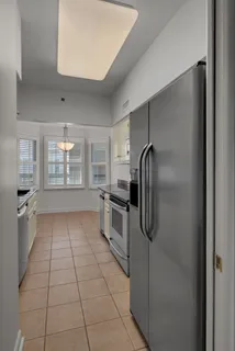 a kitchen with a refrigerator a oven and cabinets