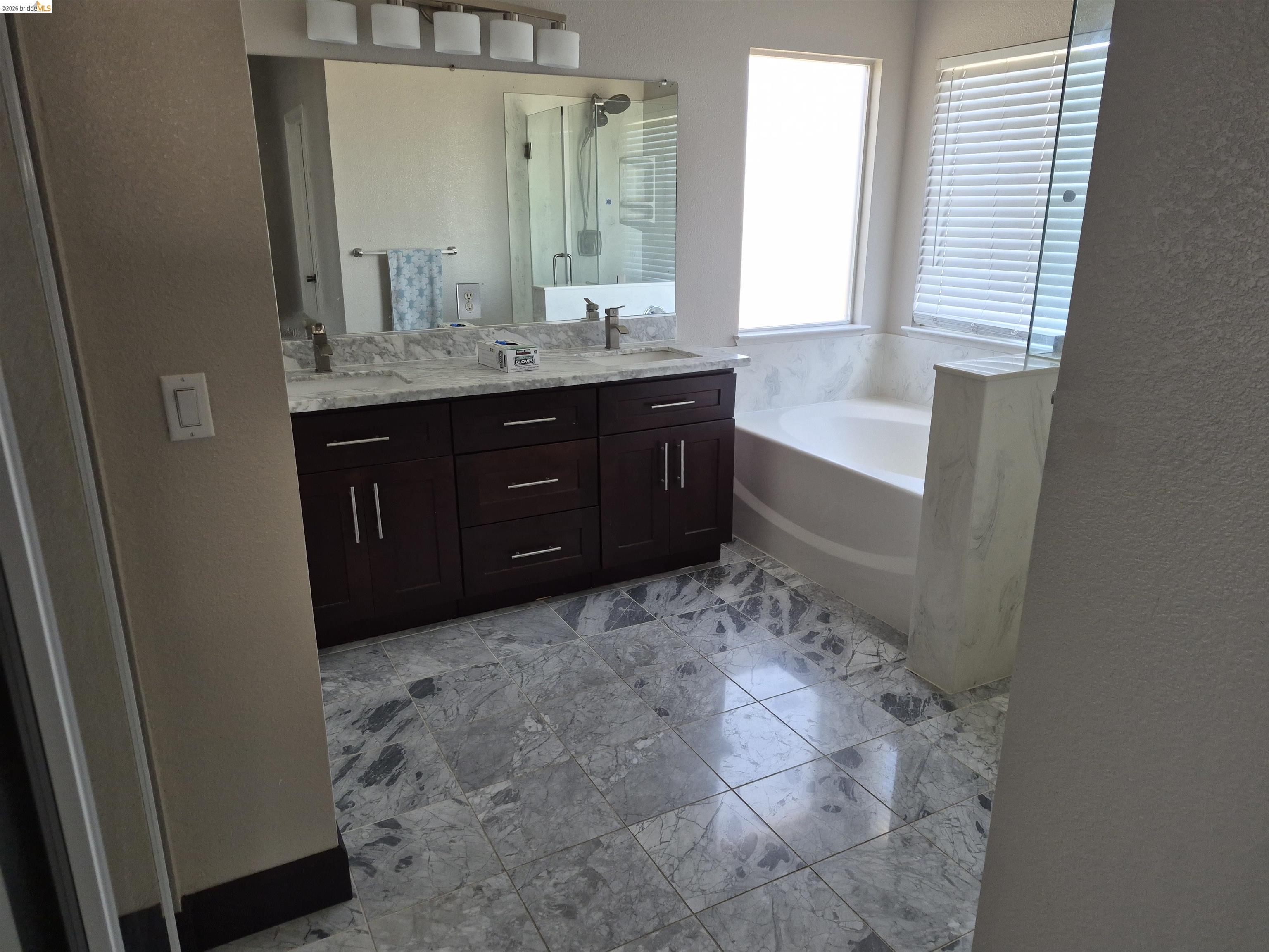 149 Oakpoint Court Bay Point, CA 94565 - Photo 7 of 22 Bathroom featuring double vanity with dark wood cabinetry, white stone countertops, and undermount sinks