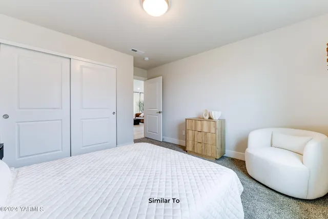 a bedroom with a bed and a couch