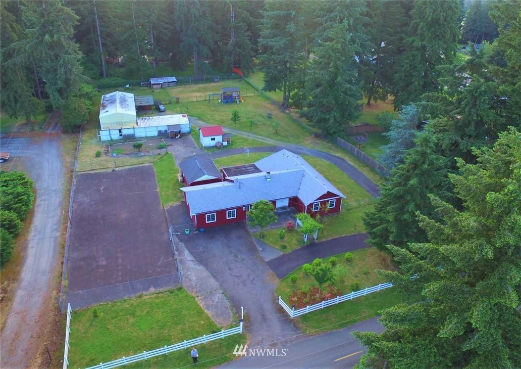 19215 Loganberry Street Southwest Rochester, WA 98579 - Photo 1 of 38 a view of backyard with seating area and green space