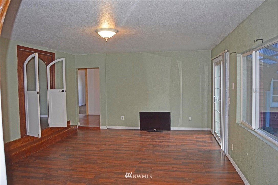 19215 Loganberry Street Southwest Rochester, WA 98579 - Photo 11 of 38 a view of empty room with wooden floor and fan
