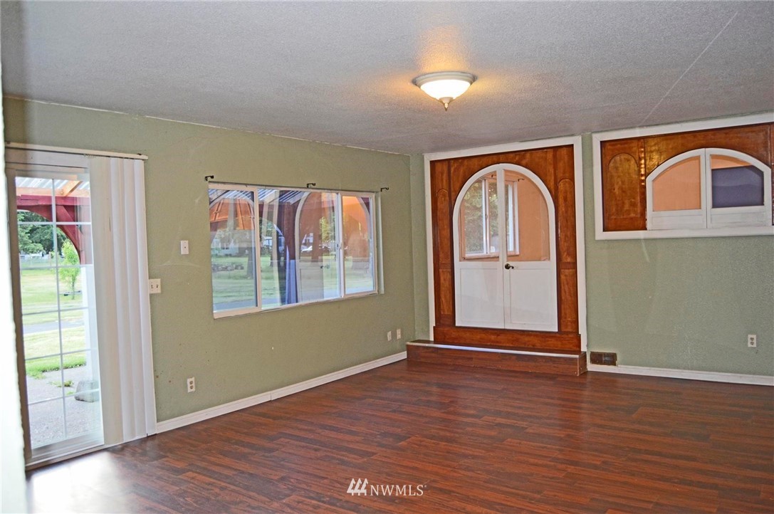 19215 Loganberry Street Southwest Rochester, WA 98579 - Photo 13 of 38 an empty room with wooden floor closet and windows