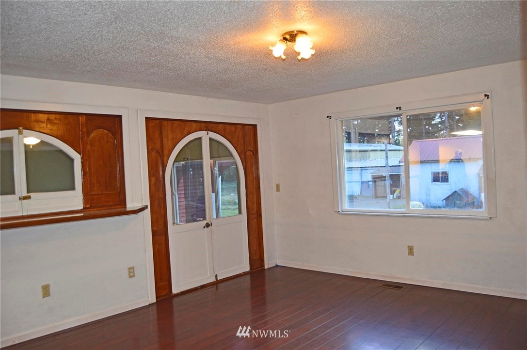19215 Loganberry Street Southwest Rochester, WA 98579 - Photo 15 of 38 a view of a livingroom with wooden floor and chandelier