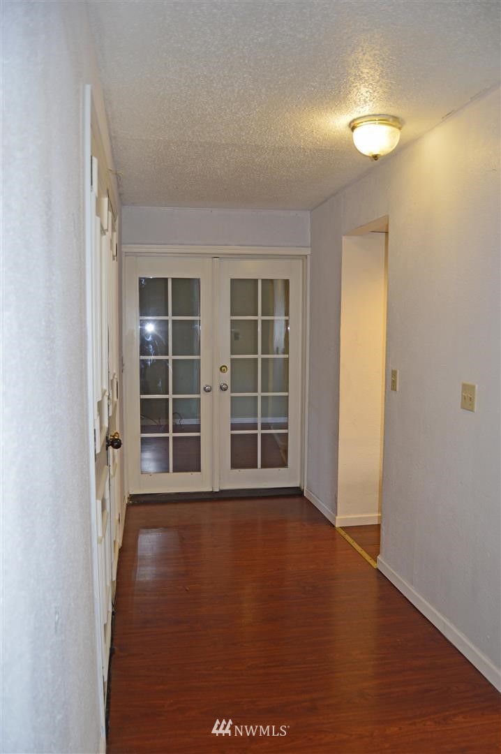 19215 Loganberry Street Southwest Rochester, WA 98579 - Photo 16 of 38 an empty room with wooden floor and windows