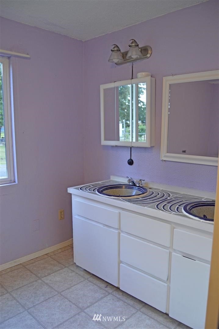 19215 Loganberry Street Southwest Rochester, WA 98579 - Photo 17 of 38 a kitchen with a sink cabinets and window