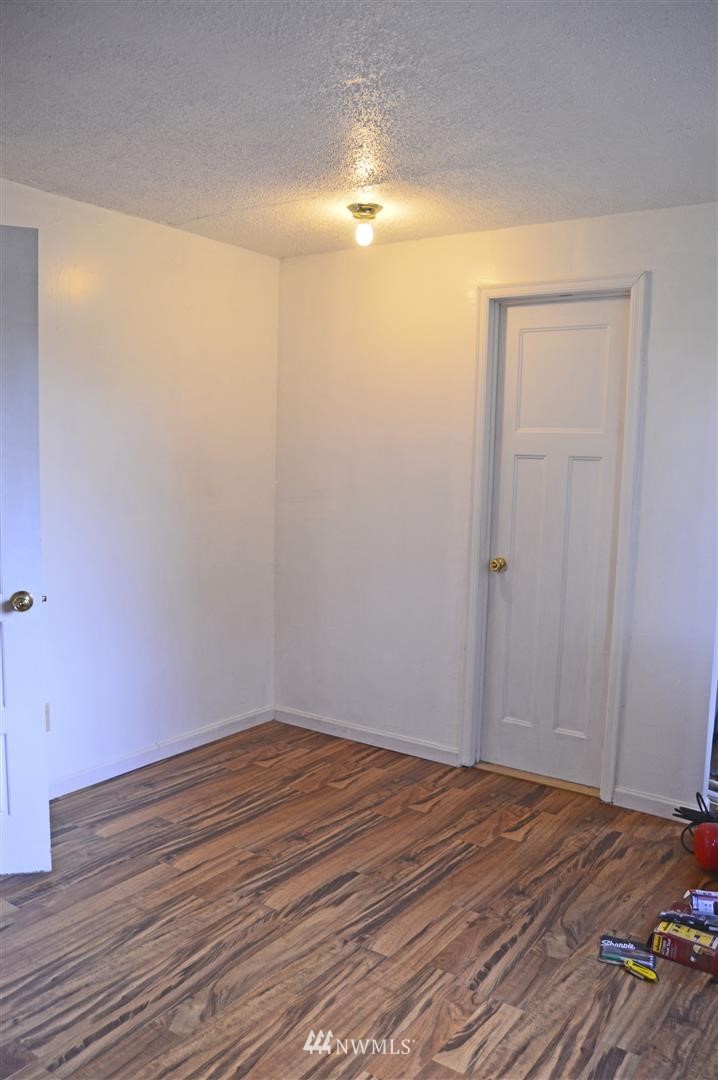 19215 Loganberry Street Southwest Rochester, WA 98579 - Photo 19 of 38 a view of empty room with wooden floor