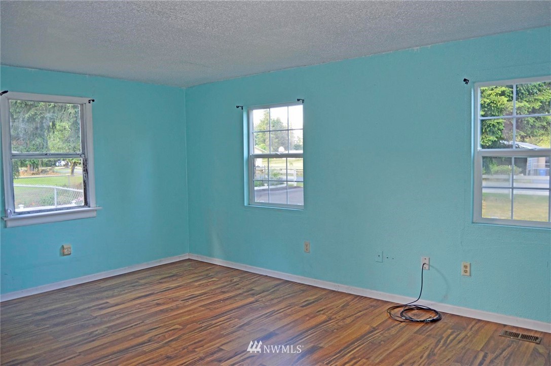 19215 Loganberry Street Southwest Rochester, WA 98579 - Photo 21 of 38 a view of a room with wooden floor and windows