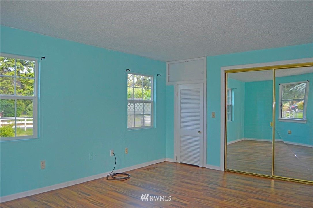 19215 Loganberry Street Southwest Rochester, WA 98579 - Photo 22 of 38 a view of an empty room with window and wooden floor