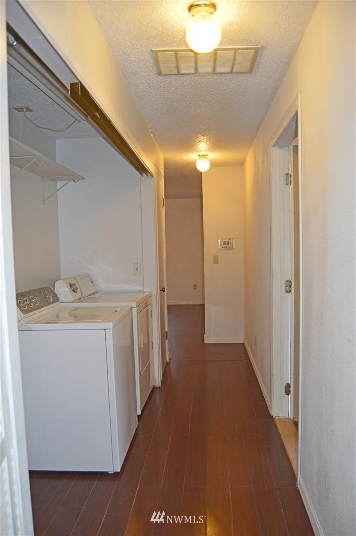 19215 Loganberry Street Southwest Rochester, WA 98579 - Photo 25 of 38 a view of a hallway with a washer and dryer