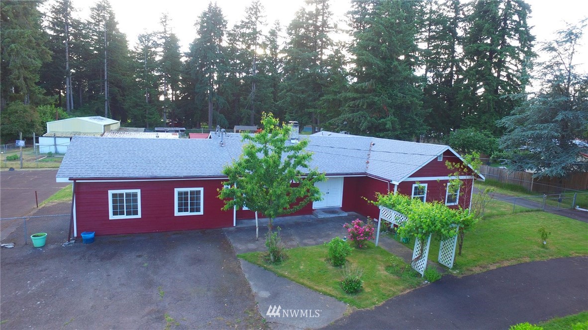 19215 Loganberry Street Southwest Rochester, WA 98579 - Photo 36 of 38 a view of a house with a yard and tree s
