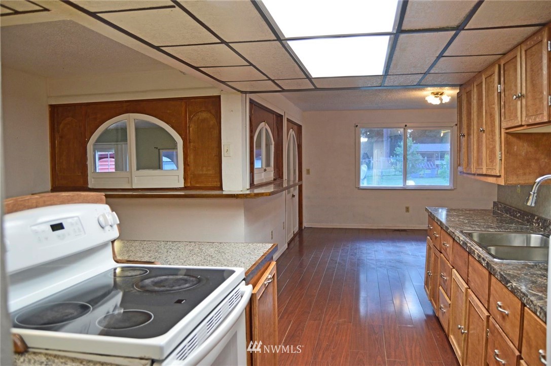 19215 Loganberry Street Southwest Rochester, WA 98579 - Photo 6 of 38 a kitchen with a sink and a stove top oven