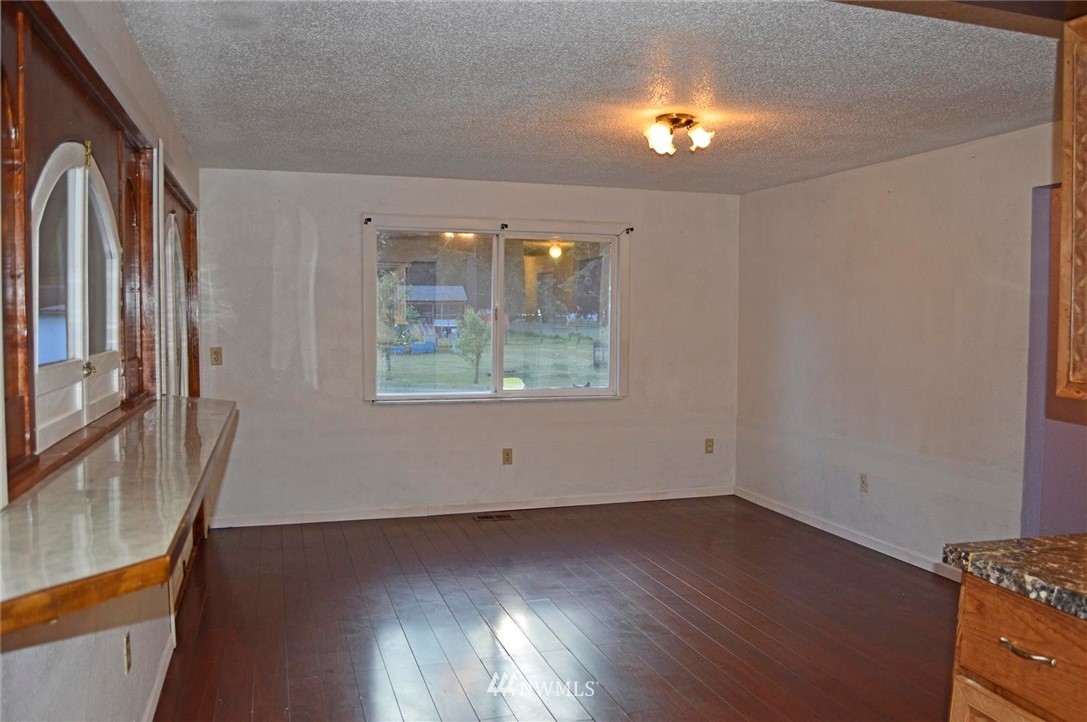 19215 Loganberry Street Southwest Rochester, WA 98579 - Photo 8 of 38 an empty room with wooden floor and windows