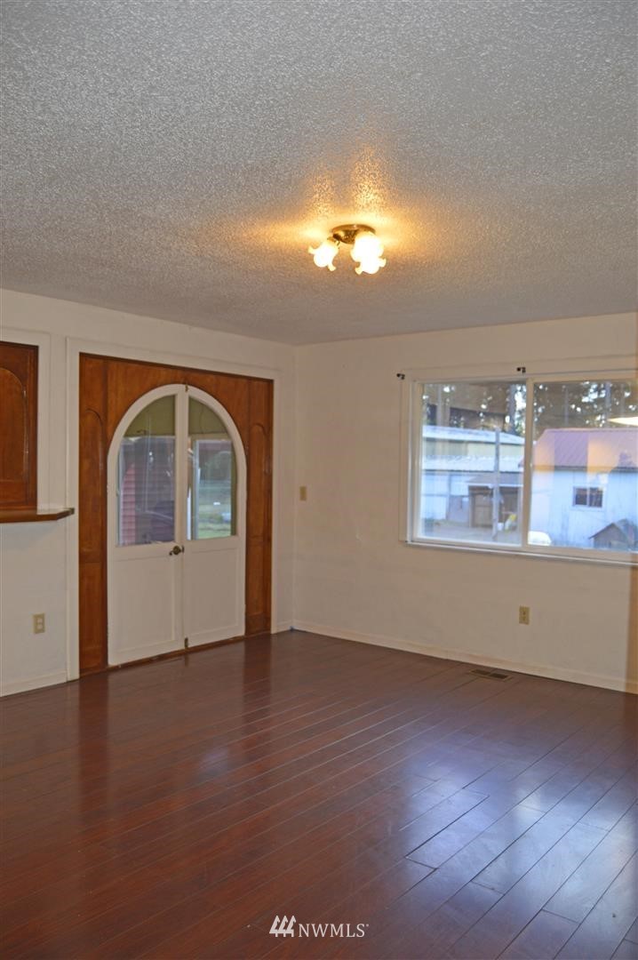 19215 Loganberry Street Southwest Rochester, WA 98579 - Photo 9 of 38 a view of room with window and wooden floor