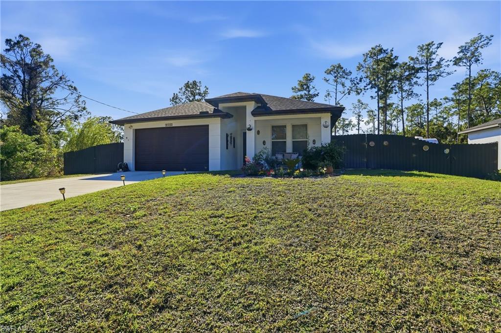 3409 64th Street West Lehigh Acres, FL 33971 - Photo 1 of 44 a view of house with yard and entertaining space