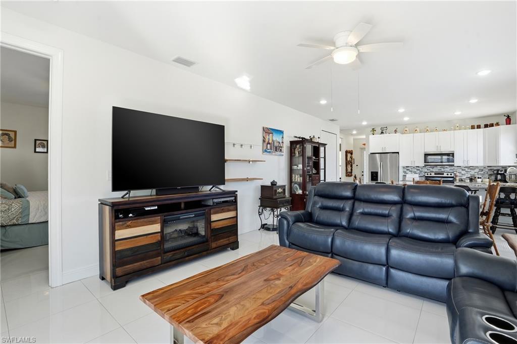 3409 64th Street West Lehigh Acres, FL 33971 - Photo 13 of 44 a living room with furniture and a flat screen tv