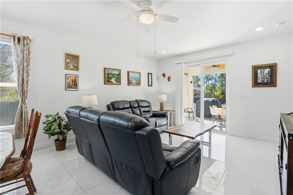 3409 64th Street West Lehigh Acres, FL 33971 - Photo 14 of 44 a living room with furniture and a chandelier