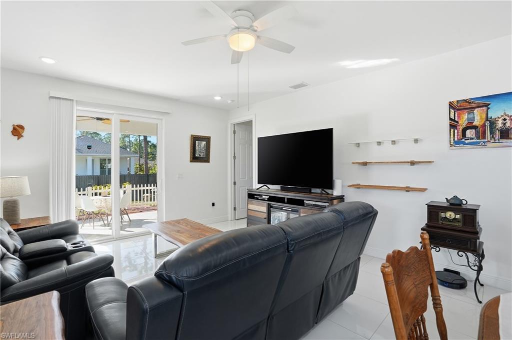 3409 64th Street West Lehigh Acres, FL 33971 - Photo 15 of 44 a living room with furniture and a flat screen tv