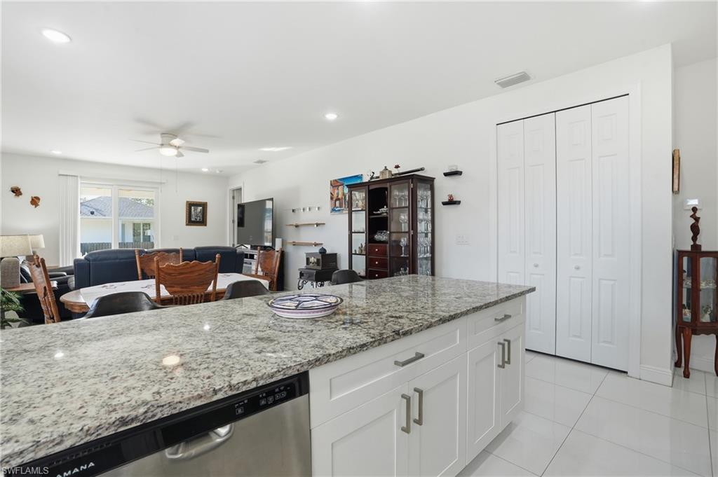 3409 64th Street West Lehigh Acres, FL 33971 - Photo 44 of 44 a kitchen with counter top space cabinets and stainless steel appliances