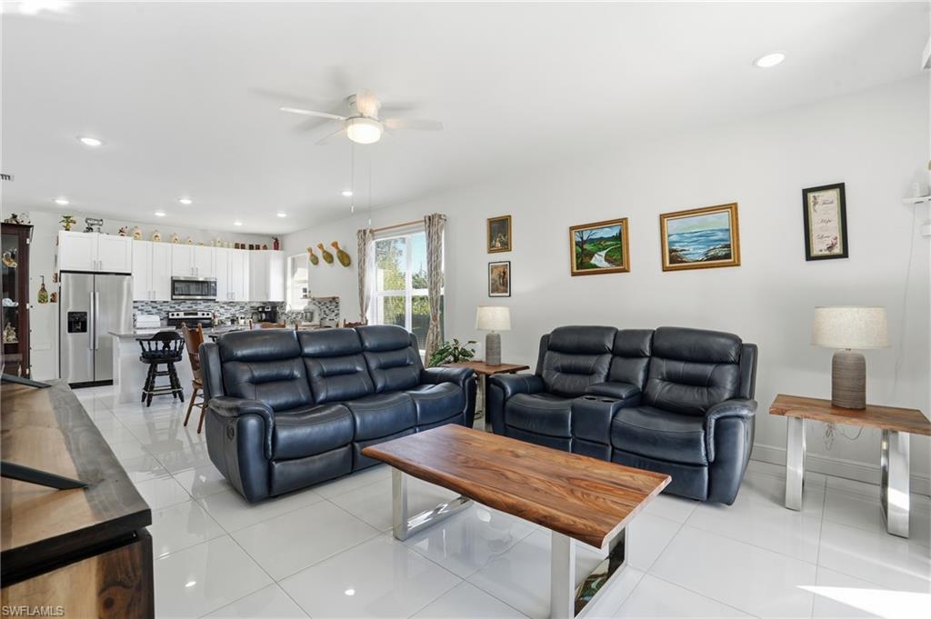 3409 64th Street West Lehigh Acres, FL 33971 - Photo 2 of 44 a living room with furniture and kitchen view
