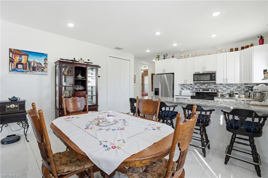 3409 64th Street West Lehigh Acres, FL 33971 - Photo 20 of 44 a view of a dining room with furniture