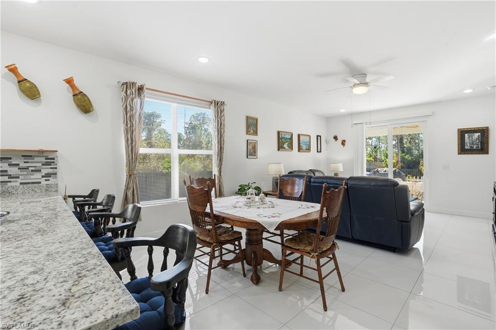 3409 64th Street West Lehigh Acres, FL 33971 - Photo 22 of 44 a view of a dining room with furniture and a window