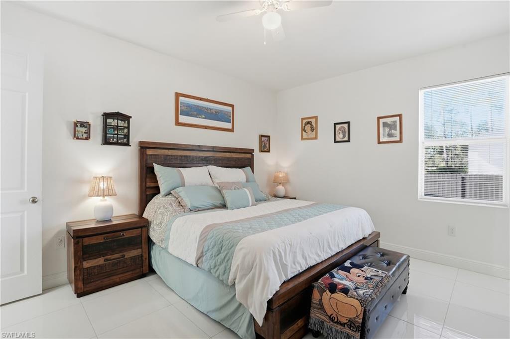 3409 64th Street West Lehigh Acres, FL 33971 - Photo 24 of 44 a bedroom with a bed and a window