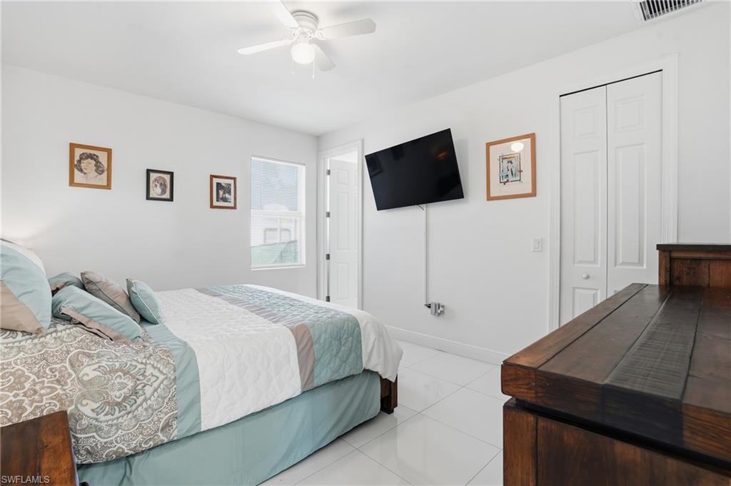 3409 64th Street West Lehigh Acres, FL 33971 - Photo 26 of 44 a bedroom with a bed and a flat screen tv