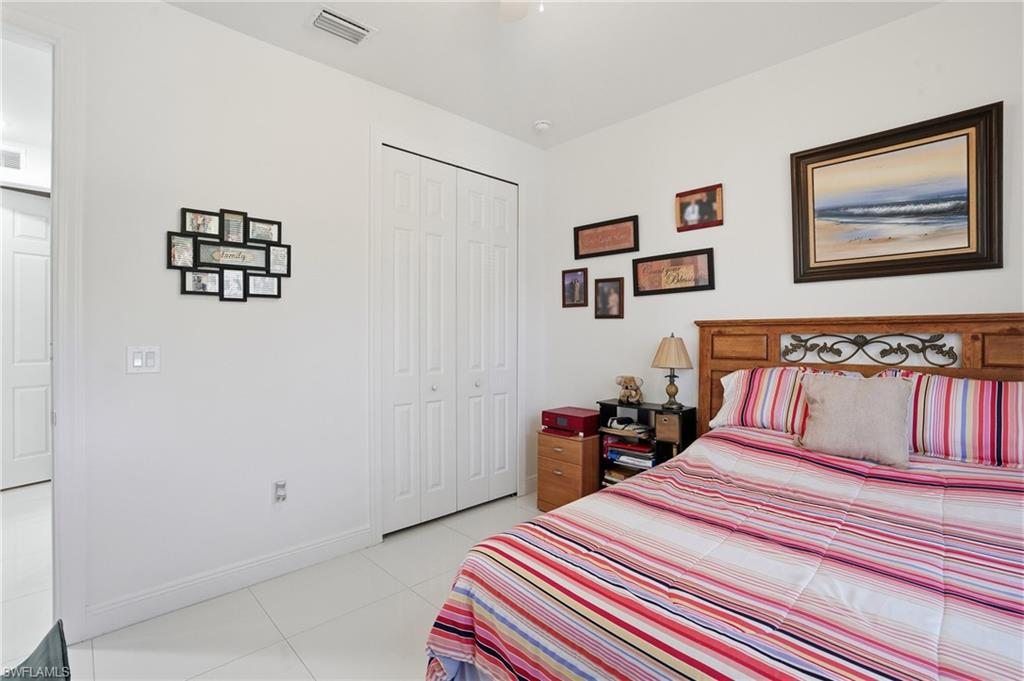 3409 64th Street West Lehigh Acres, FL 33971 - Photo 28 of 44 a bedroom with bed and wooden floor