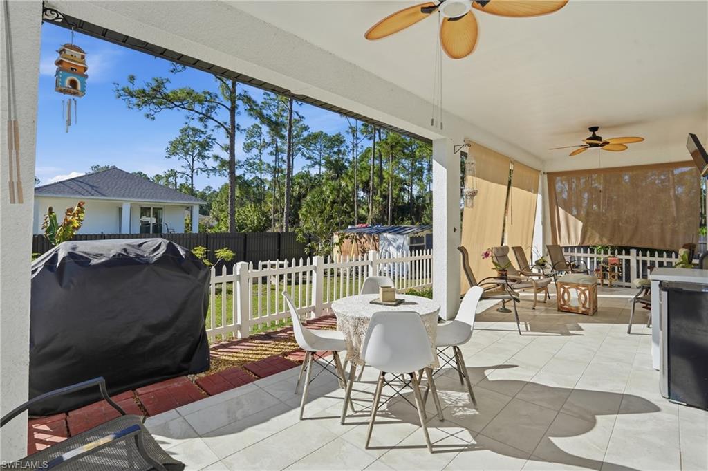 3409 64th Street West Lehigh Acres, FL 33971 - Photo 31 of 44 a dining room with furniture water view and a floor to ceiling window