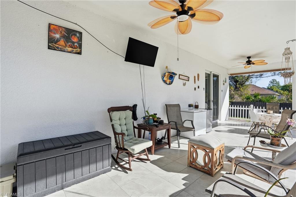 3409 64th Street West Lehigh Acres, FL 33971 - Photo 32 of 44 a living room with furniture and a flat screen tv