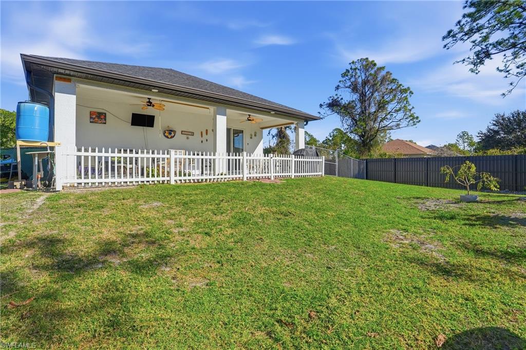 3409 64th Street West Lehigh Acres, FL 33971 - Photo 34 of 44 front view of a house with a yard