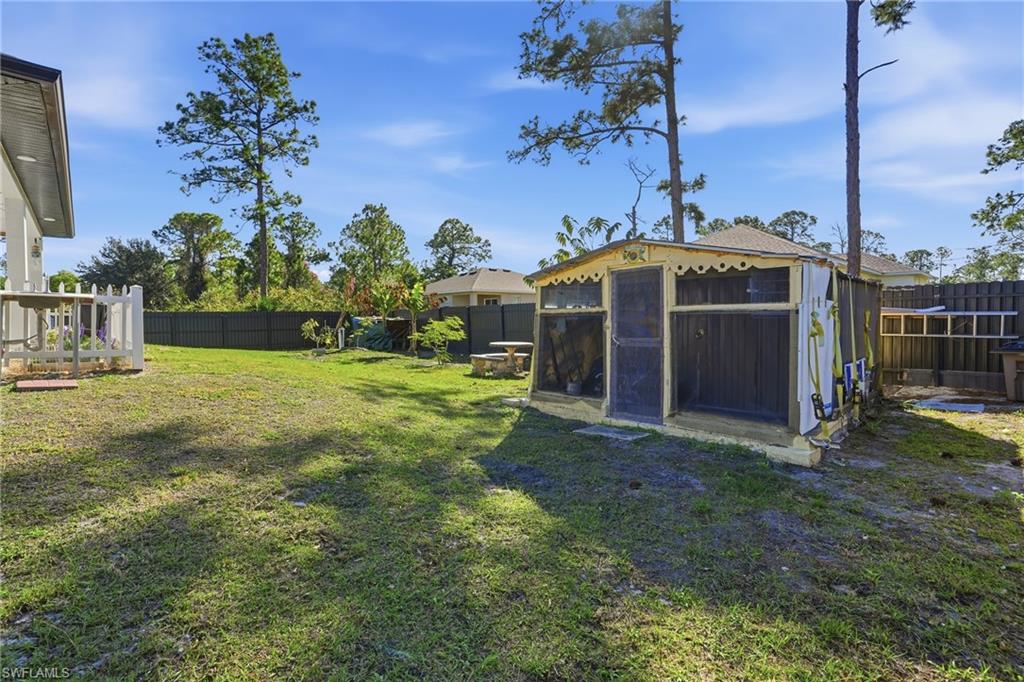 3409 64th Street West Lehigh Acres, FL 33971 - Photo 35 of 44 a view of a house with a yard